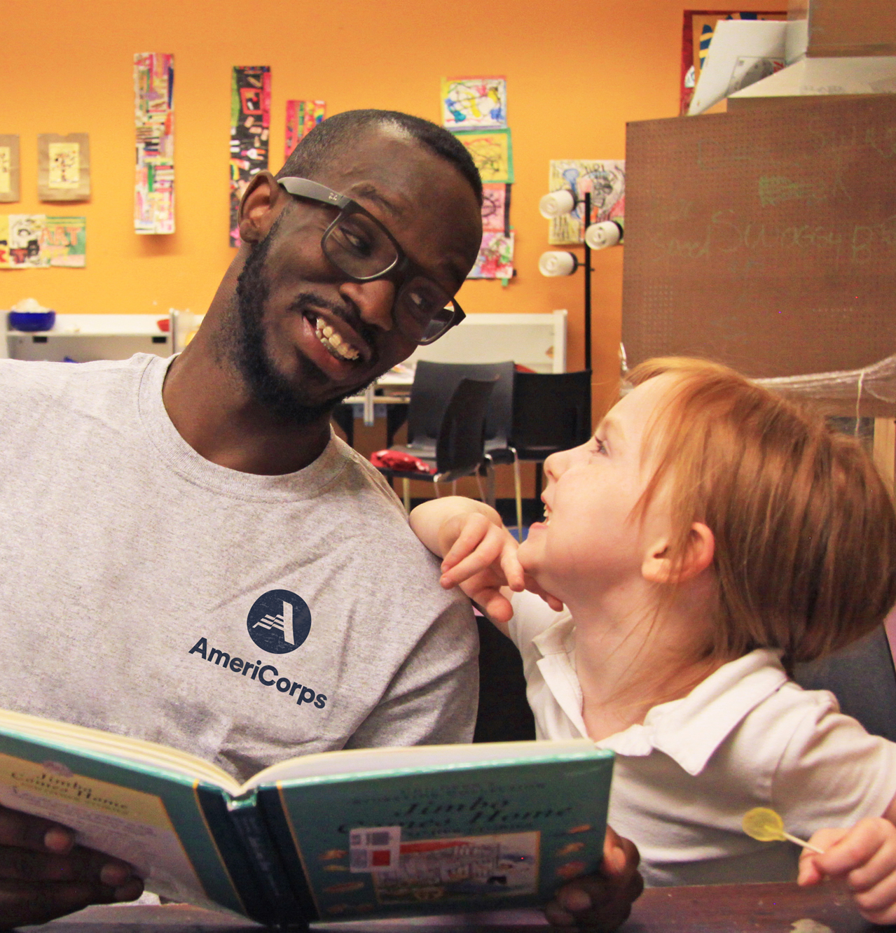 AmeriCorps Mentor Reading to Boy